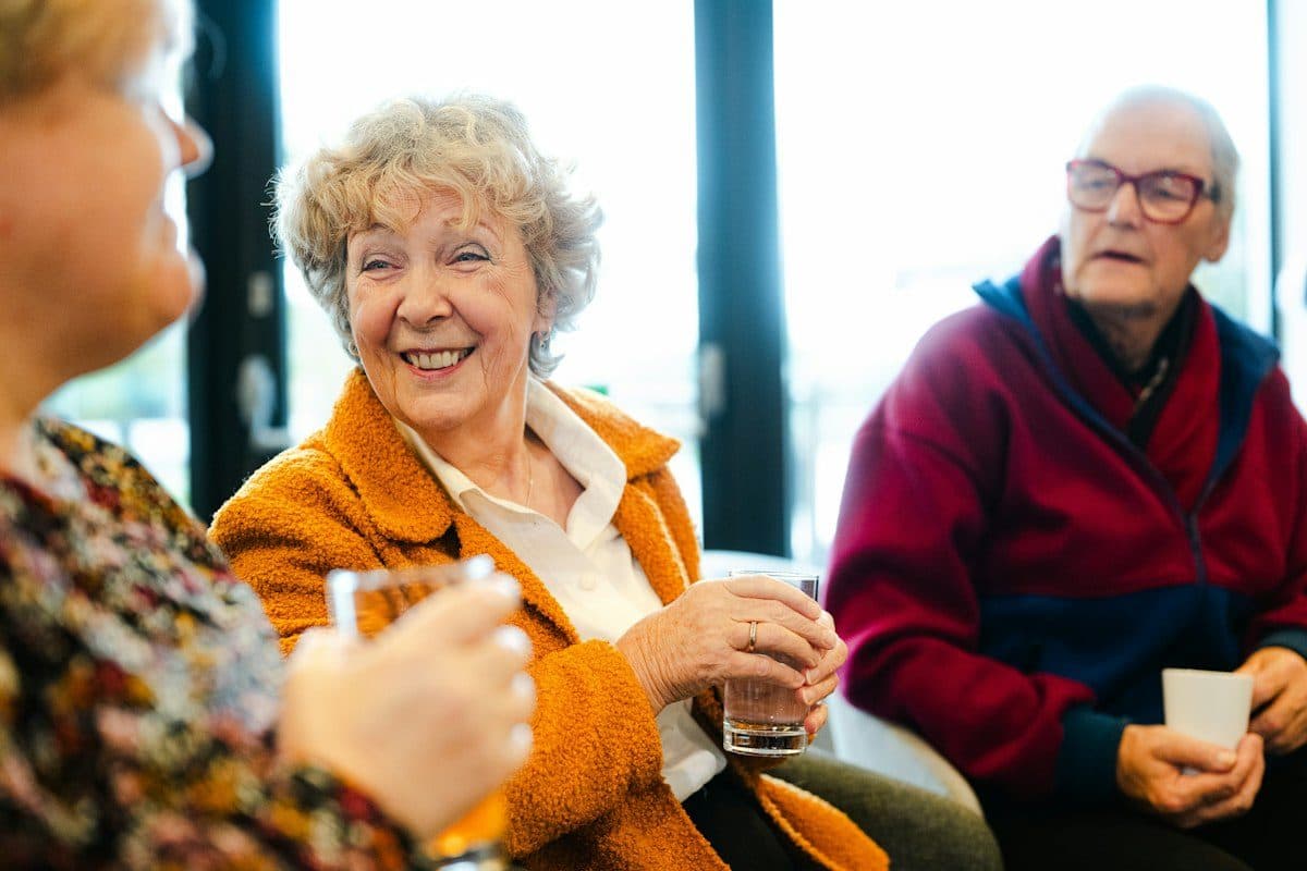Residents laughing together in a senior living common room